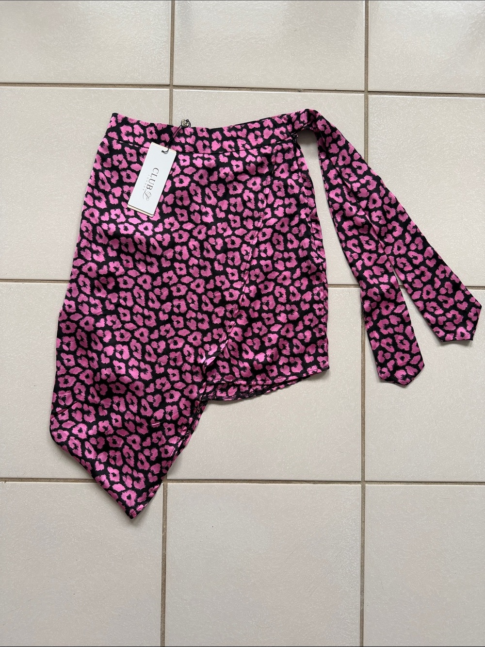 This Club L London skirt is a pink leopard print mini skirt featuring a side tie